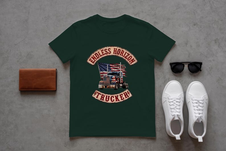 May include: A dark green short-sleeved t-shirt featuring a graphic of a semi-truck in front of an American flag, with the text ENDLESS HORIZON TRUCKER in a distressed red font. The shirt is displayed alongside a brown leather wallet and sunglasses.