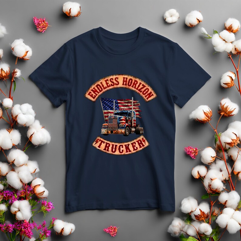 May include: A navy blue t-shirt featuring a graphic print of a semi-truck with an American flag design. The graphic is framed by two curved banners with the text ENDLESS HORIZON at the top and TRUCKER at the bottom in a distressed red font.