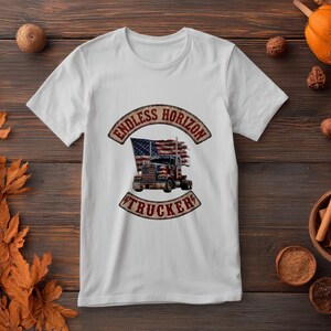 May include: A white short-sleeve t-shirt featuring a central graphic of a semi-truck with an American flag background. The design is enclosed in a curved banner with the text ENDLESS HORIZON at the top and TRUCKER at the bottom in brown.