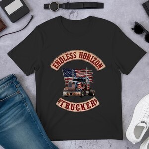 May include: A black short-sleeved t-shirt featuring a graphic of a semi-truck with an American flag design. The text ENDLESS HORIZON TRUCKER is printed in a distressed red font in an arched banner above and below the truck illustration.