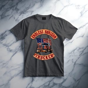 May include: A charcoal grey short-sleeve t-shirt featuring a graphic print of a semi-truck with an American flag design. The text ENDLESS HORIZON is arched above the truck, and the word TRUCKER is arched below, both in a distressed red font.
