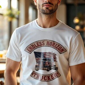 May include: A white short-sleeve t-shirt featuring a graphic print of a semi-truck with an American flag design. The text ENDLESS HORIZON is arched above the truck, and the word TRUCKER is arched below, both in a weathered, vintage-style font.
