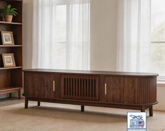 Modern media center with a TV stand featuring roller-style sliding doors and louvered flip-down doors, suitable for a 75-inch TV.