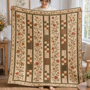 May include: A rectangular quilt featuring vertical panels with alternating floral patterns and checkered blocks. The design incorporates shades of cream, olive green, rust orange, and brown. The quilt has a decorative border with a floral motif.