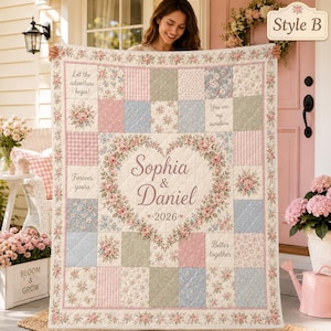 May include: A patchwork quilt featuring a floral and gingham pattern in pastel pink, blue, and green. A central heart wreath surrounds the text Sophia & Daniel 2026. Additional text includes Let the adventure begin, You are my sunshine, Forever yours, and Better together.