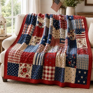 May include: A patchwork quilt featuring a variety of square fabric blocks in red, white, and blue. The patterns include floral prints, gingham checks, stars, and stripes. The quilt is finished with a solid red border and visible quilted stitching.