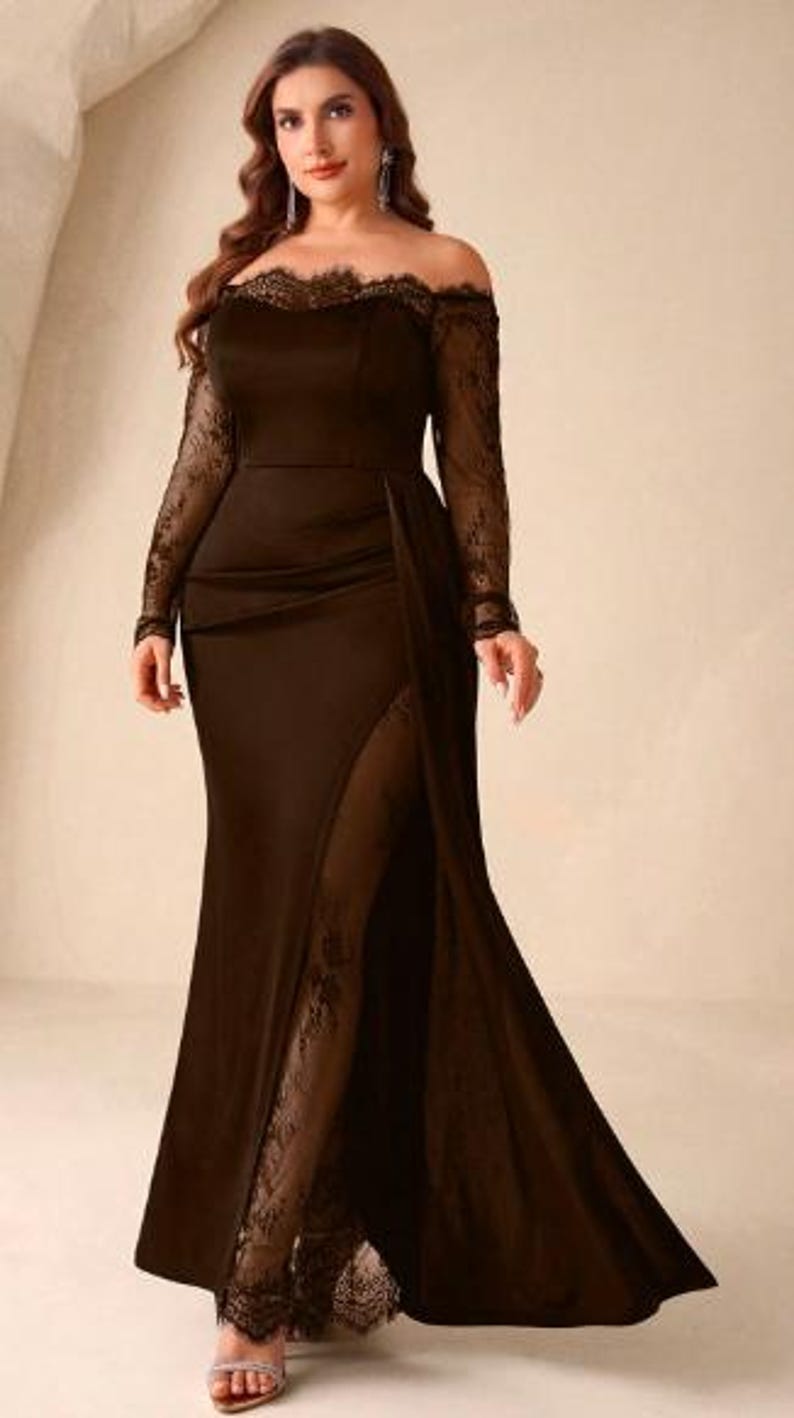 May include: A floor-length dark brown gown featuring an off-the-shoulder neckline with delicate lace trim, long sheer lace sleeves, and a high side slit that reveals a lace-lined panel extending down to the hem of the skirt.