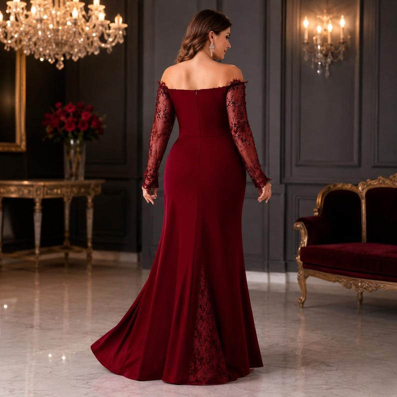 May include: A floor-length, off-the-shoulder burgundy gown featuring long, sheer lace sleeves and a matching lace panel insert at the back of the skirt. The dress has a fitted bodice and a flared hemline, showcasing a solid, smooth fabric texture.