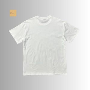 May include: A plain white short-sleeved t-shirt with a crew neckline. The garment features a solid white color throughout, with a small square logo in the top left corner containing a brown line drawing of a guitar and the text GuitarCraft.