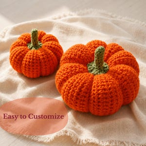 May include: Two handmade crochet pumpkins in bright orange yarn with textured green stems. The pumpkins feature a rounded, ribbed shape. The text "Easy to Customize" is visible in the lower left corner of the image, written in a dark maroon font.