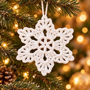 May include: A white crocheted snowflake ornament with a six-pointed star design and intricate openwork patterns. The ornament is crafted from white yarn and features a small loop at the top for hanging, showcasing a detailed handmade texture.