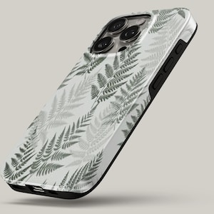 May include: A smartphone case featuring a repeating pattern of dark green fern leaves on a light gray background. The case has a black border, cutouts for the camera lenses, and side buttons, showcasing a slim profile and a protective design.