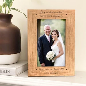 May include: A light oak picture frame with the text "Dad, of all the walks we've taken together" and "This one's my favourite Love Georgia". The frame contains a photograph of a man and a woman.