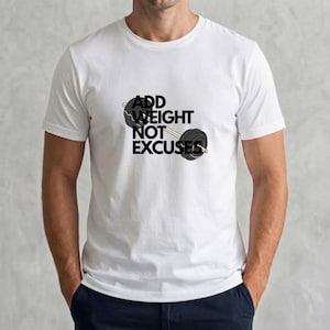 Pode incluir: Uma t-shirt branca de manga curta com um gráfico de uma barra de pesos com discos pretos. O texto "ADD WEIGHT NOT EXCUSES" está impresso em letras maiúsculas pretas e negrito no centro do peito, sobreposto ao gráfico da barra de pesos.