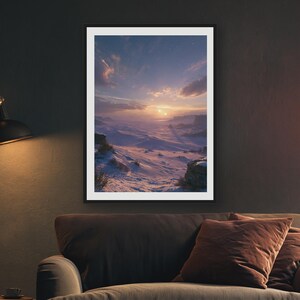 May include: A framed vertical wall art print depicting a vast, snow-covered landscape under a twilight sky. The scene features rolling white dunes, rocky outcrops, and a glowing sun near the horizon, casting long shadows across the frozen terrain.