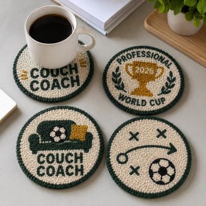 May include: Four round, cream-colored tufted coasters with dark green borders. Designs include the text "COUCH COACH" with a sofa and soccer ball, a "PROFESSIONAL WORLD CUP 2026" trophy graphic, and a soccer tactical play diagram with a ball.