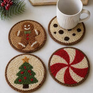 May include: Four round, hand-stitched coasters with festive designs. One shows a gingerbread man, another a chocolate chip cookie, a Christmas tree, and a red and white peppermint swirl. A white mug rests on one coaster.