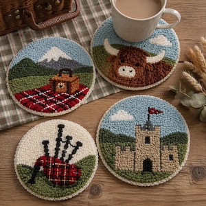 May include: Four circular punch needle coasters displaying textured motifs: a picnic scene with a mountain, a brown highland cow, bagpipes on a cream background, and a stone castle with a red flag, all created using colourful yarn loops.