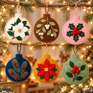 May include: Six circular felt ornaments featuring embroidered botanical designs. The ornaments display a white magnolia, white berries on brown, holly leaves with red berries on pink, pine needles on navy, a red poinsettia, and green leaves with red berries.