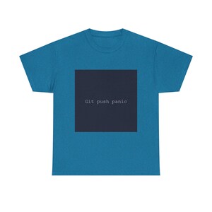 May include: A teal t-shirt with a dark blue square in the center. The square contains the text "Git push panic" in white, sans-serif font. The shirt is a crew neck style.
