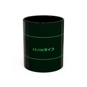 May include: Black ceramic coffee mug with a green horizontal stripe design. The mug features the text "CI/CD ライフ" in green. The mug has a black interior and a glossy finish.