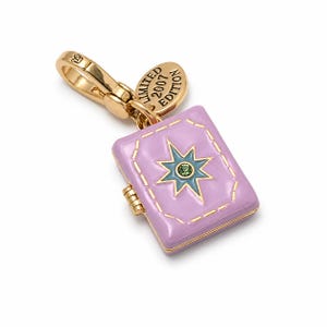 May include: A gold-tone metal charm shaped like a small book with a lavender enamel finish. The cover features a blue star design with a central green crystal. A small gold tag attached to the lobster clasp is engraved with LIMITED 2007 EDITION.
