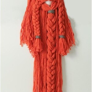 May include: A handmade Viking hat and beard set. The grey hat has white horns, and the beard is a vibrant orange, featuring a braided design with grey accents. This unique costume piece is perfect for themed events.