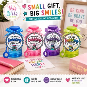 May include: Four plastic bubble bottles in blue, pink, purple, and green, each topped with a matching polka-dot ribbon and a circular tag reading I'VE BEEN BUBBLING WITH EXCITEMENT TO MEET YOU! with a small illustration of a bubble jar.