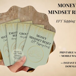 May include: A set of four sage green cards with gold glitter accents at the top and gold line art symbols. The cards feature the text Money Mindset Reset EFT Tapping Cards, Self, Emotional Release, and Grounding. Includes printable A6 cards.