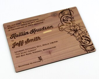 May include: A wooden wedding invitation with a floral design and the text "MR. AND MRS. WILLIAM KNUDSON REQUEST THE HONOR OF YOUR PRESENCE AT THE MARRIAGE OF THEIR DAUGHTER Kaitlin Knudson TO Jeff Smith SATURDAY, SEPTEMBER 18TH, 2010 AT 5:00 P.M. "THE SECRET GARDEN" 2621 BEST ROAD, VERADALE, WASHINGTON RECEPTION TO FOLLOW"