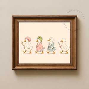 May include: A framed print featuring four white ducks walking in a line. The first duck wears a pink shower cap and holds a brush. The second wears a green towel wrap. The third wears a blue bathrobe. The fourth holds a pink toothbrush.