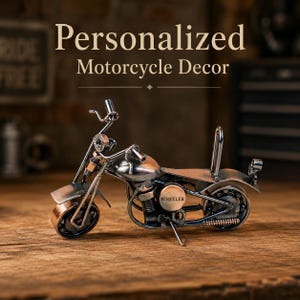 May include: A metal motorcycle sculpture crafted from repurposed hardware components, featuring a copper and silver finish. The side engine cover is clearly engraved with the text WHEELER. The design includes a front fender, handlebars, a seat, and a rear sissy bar, all constructed from various metal parts.