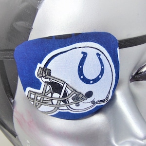 May include: Blue eye patch with a white football helmet and horseshoe logo. The logo is blue and white and says "Colts" on the helmet.