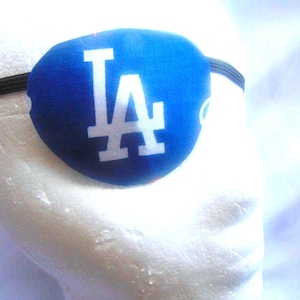 May include: Blue eye patch with a white "LA" logo.