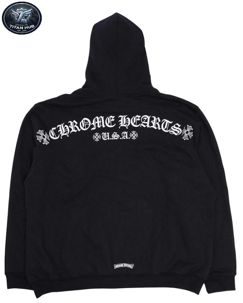 May include: Black hooded sweatshirt with the text "CHROME HEARTS U.S.A." in white script across the back. The sweatshirt has a drawstring hood and a kangaroo pocket. The Chrome Hearts logo is visible on the back.