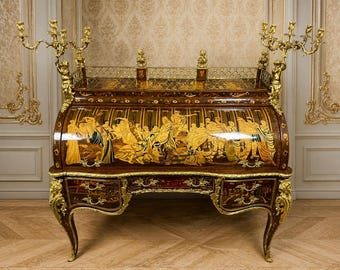 A roll-top desk with a marquetry center and richly ornamented with bronze mounts.