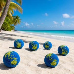 May include: Six blue and yellow crocheted globe-shaped balls are arranged on a sandy beach. The balls are detailed with continents in yellow against a blue background, with a tropical beach and ocean in the background.