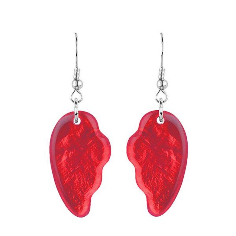 May include: A pair of red heart-shaped earrings. Each earring is a half-heart design with a textured surface, suspended from a silver-colored hook. The earrings are displayed against a white background.
