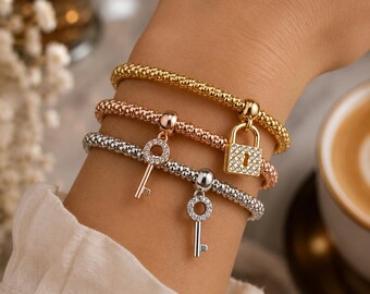 3-delige verstelbare bedelarmband in goud, zilver en roségoud met slot- en sleutelbedels