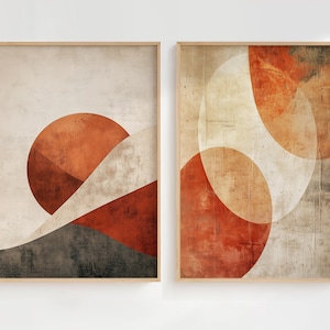Peut inclure: Deux cadres muraux présentant des compositions géométriques abstraites. L'impression de gauche affiche un grand cercle orange brûlé sur une base gris foncé et des courbes crème. Celle de droite montre des formes circulaires orange et crème.