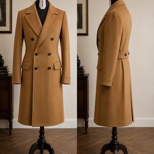 May include: A camel-coloured double-breasted overcoat featuring a notched lapel, six dark buttons on the front, two flap pockets, and cuffed sleeves. The coat is displayed on a mannequin from both a front and side profile view, showing a back belt detail.