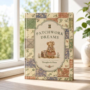 May include: A hardcover journal with a patchwork quilt pattern in shades of cream, blue, green, and red. The center features a cream label with the text PATCHWORK DREAMS, an illustration of a teddy bear holding a quilt, and the text Thoughts & Plans.