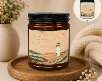 Vela "La Luz Sigue Brillando" / Regalo de ánimo, condolencias, duelo y esperanza, decoración con forma de faro, 9 aromas, de soja con tapa negra (4 y 9 oz).