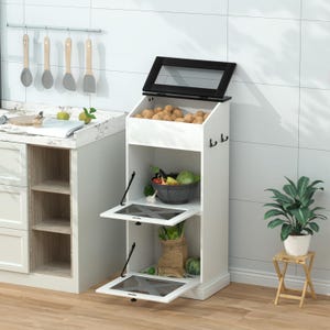 May include: A white kitchen vegetable storage unit with a black top lid featuring a mesh screen. The unit has an open top bin filled with potatoes, two lower compartments with drop-down mesh doors, and two black side hooks for hanging items.