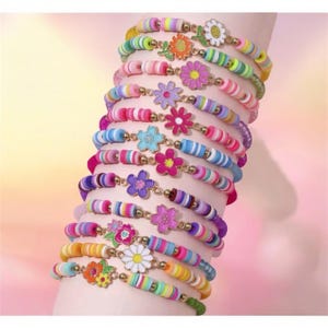 May include: A collection of twelve stacked bracelets featuring colorful polymer clay disc beads in various striped and solid patterns. Each bracelet is accented with a central metal flower charm in shades of pink, blue, yellow, orange, and white.