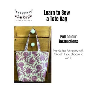 May include: A tote bag with a floral pattern in shades of purple and white. The bag is hanging on a wooden cabinet. The text "Learn to Sew a Tote Bag" is displayed above the bag, with "Full color instructions" below.