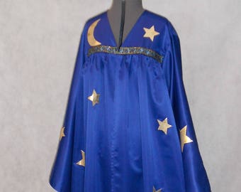 May include: A royal blue wizard robe and matching hat. The robe features gold star and crescent moon accents, with a decorative trim at the neckline. The hat has a gold crescent moon and star design. The costume is displayed on a mannequin.