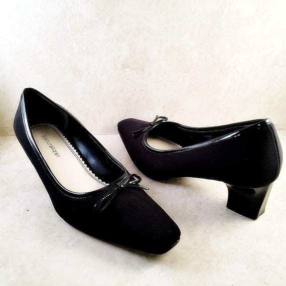 black fabric pumps