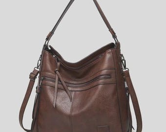 Pode incluir: Uma bolsa de ombro castanha com aspeto de couro, com vários compartimentos com zíper e uma alça longa ajustável. A bolsa tem uma superfície texturizada e uma alça de ombro menor e removível. Para uso diário.