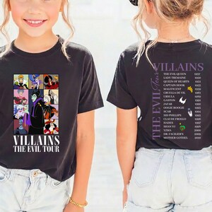 Op de afbeelding: Zwart T-shirt met een collage van tekenfilm-schurken en de tekst "VILLAINS THE EVIL TOUR". De achterkant toont een lijst van schurken en hun debuutjaren. Een kleurrijk ontwerp voor animatiefans.